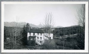 Exterior view of Crosby Girls' Home building with mountains in the back.